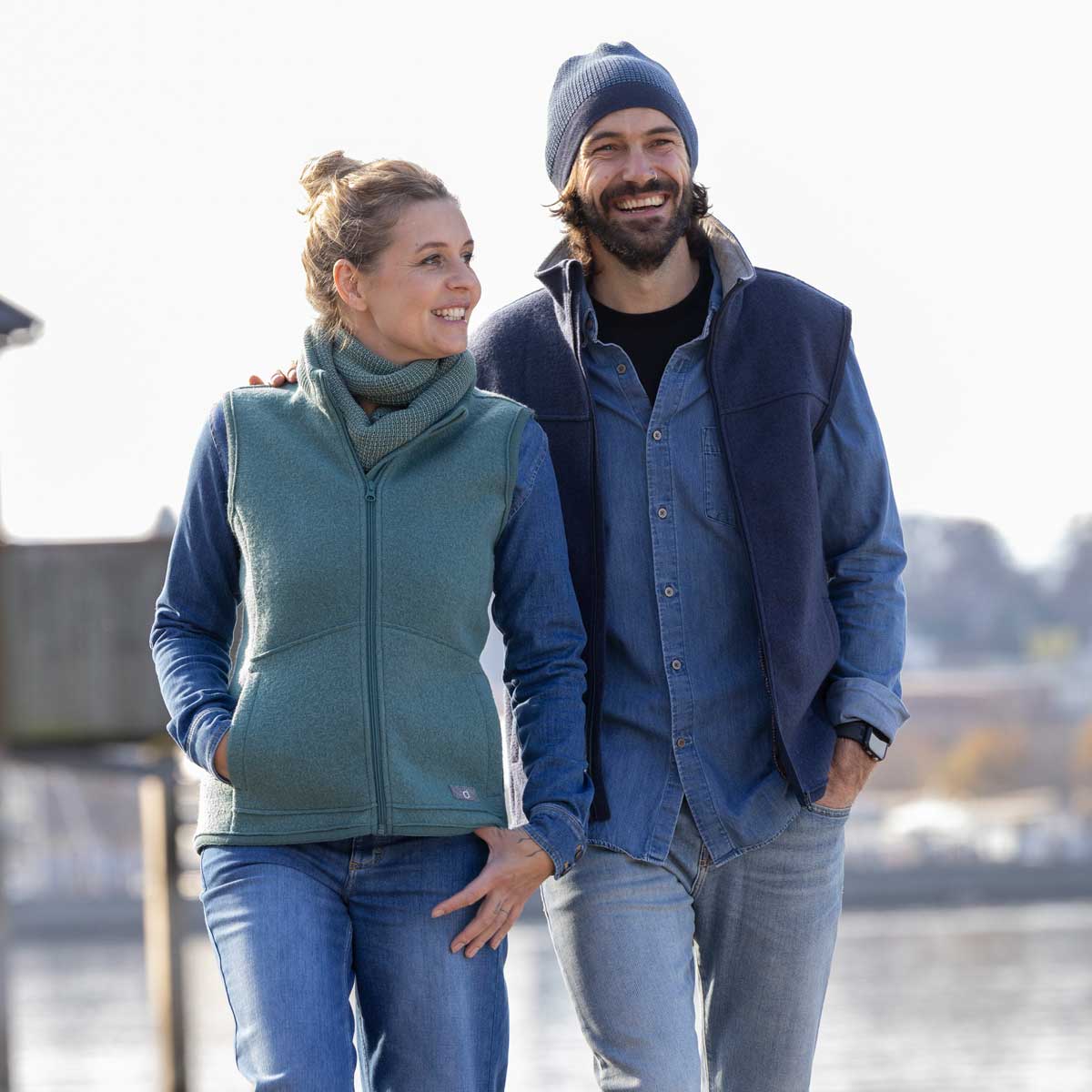 Woman and man in wool fleece vests by the water