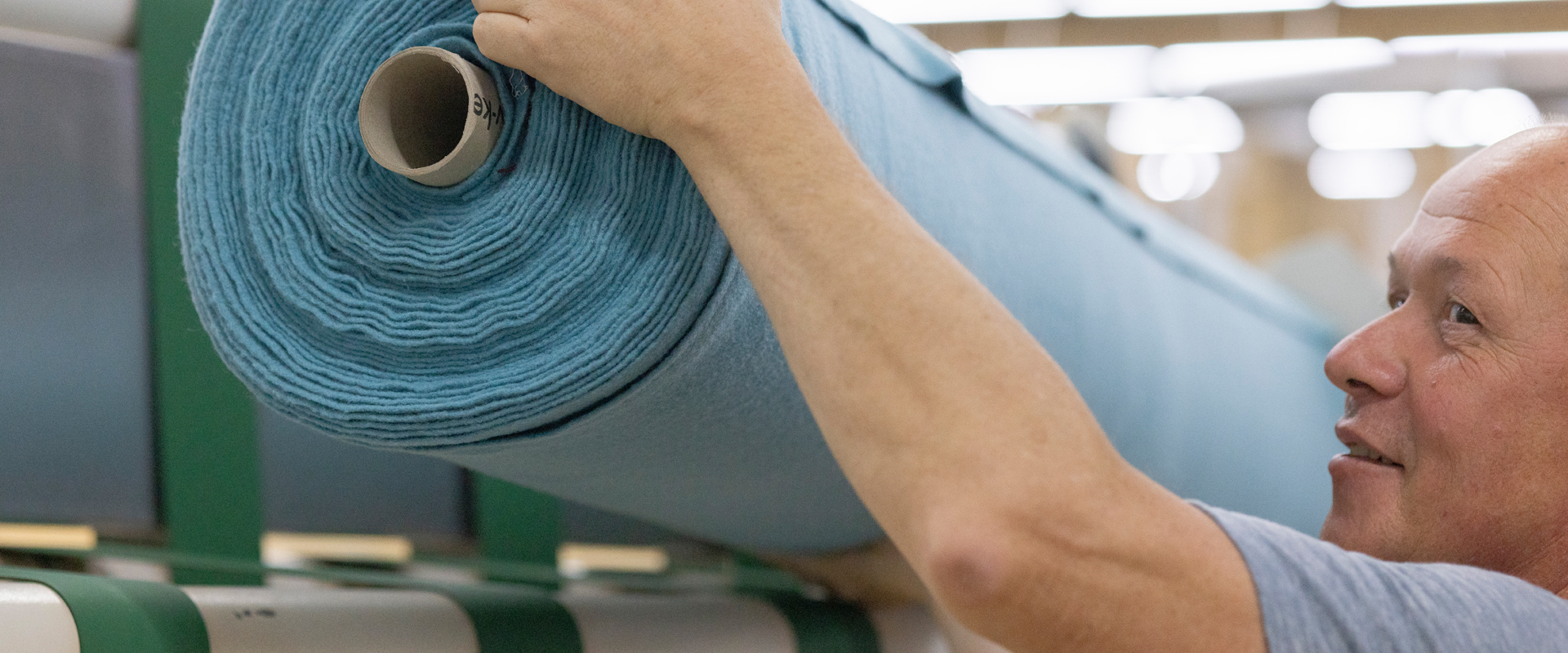 Employee loading a fabric roll for cutting