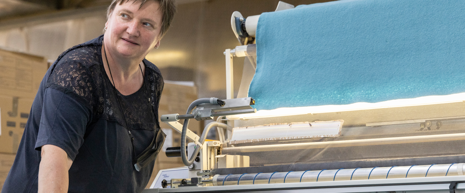 Employee spreading fabric for cutting
