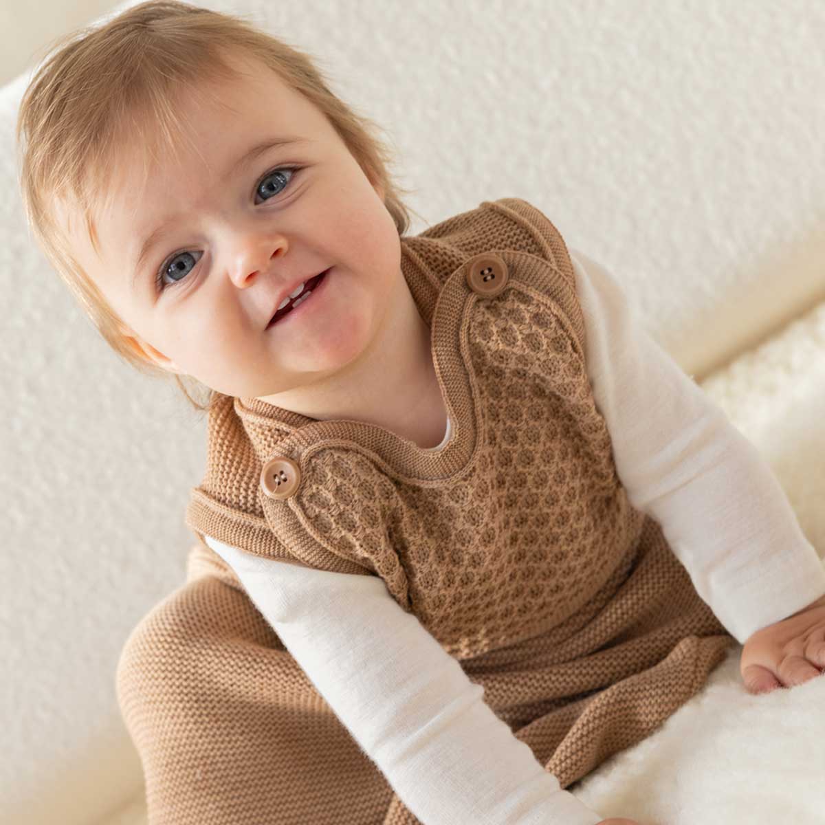 Baby in a merino wool knitted sleeping bag